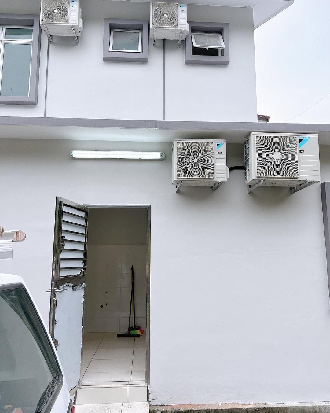 Outdoor aircond compressor units installed neatly on wall brackets